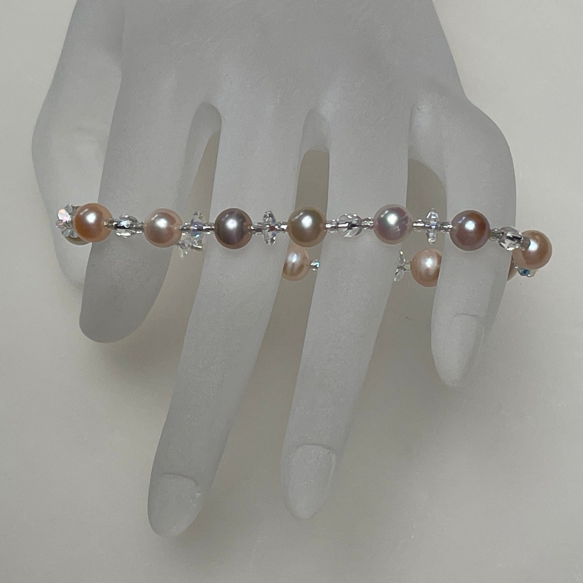 Closeup natural color pearls / Beach Roses stretch bracelet on hand display / Arpaia beachlove