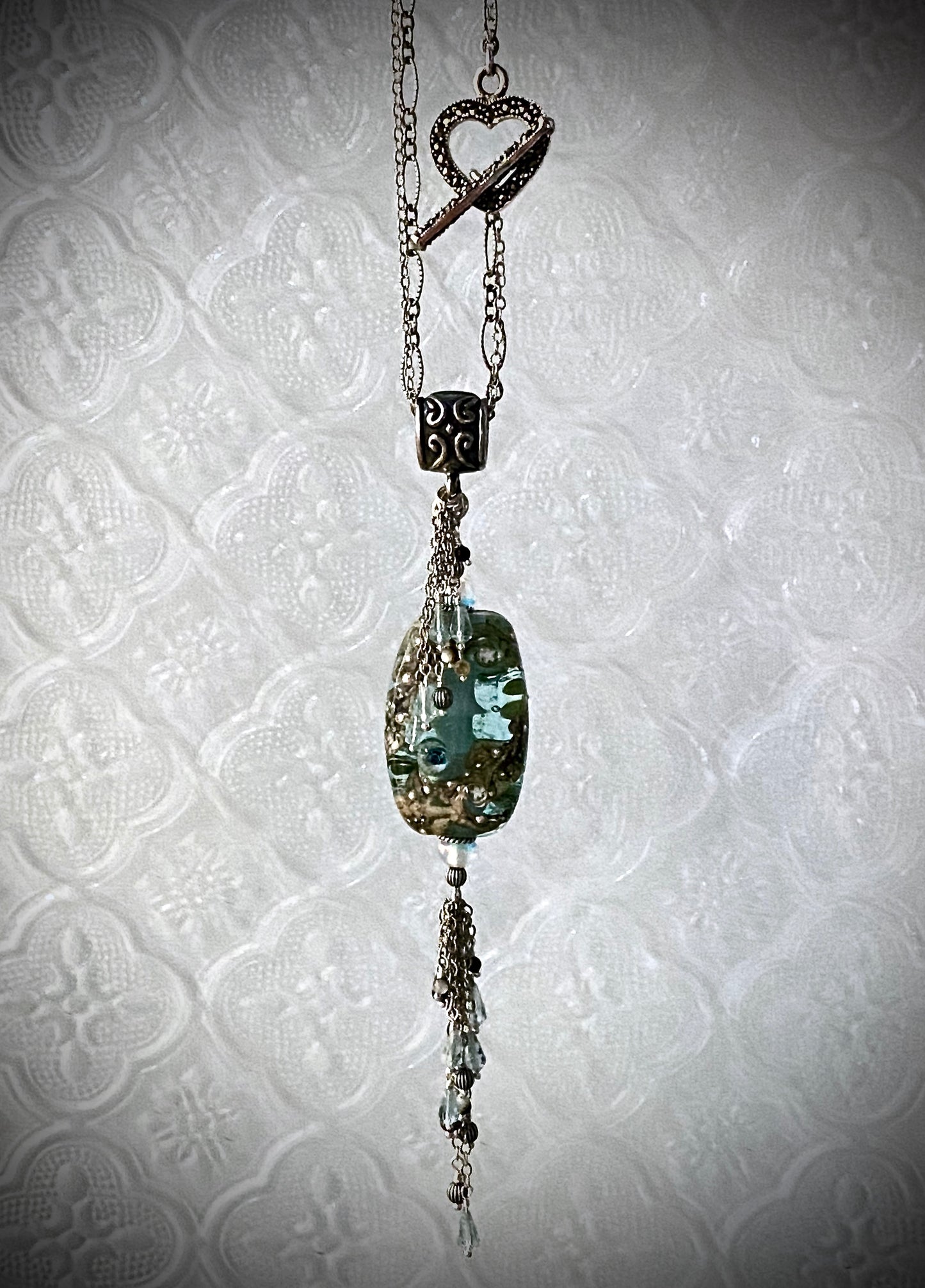 Hanging View Ezili glass & silver tassel pendant with marcasite heart clasp / Arpaia