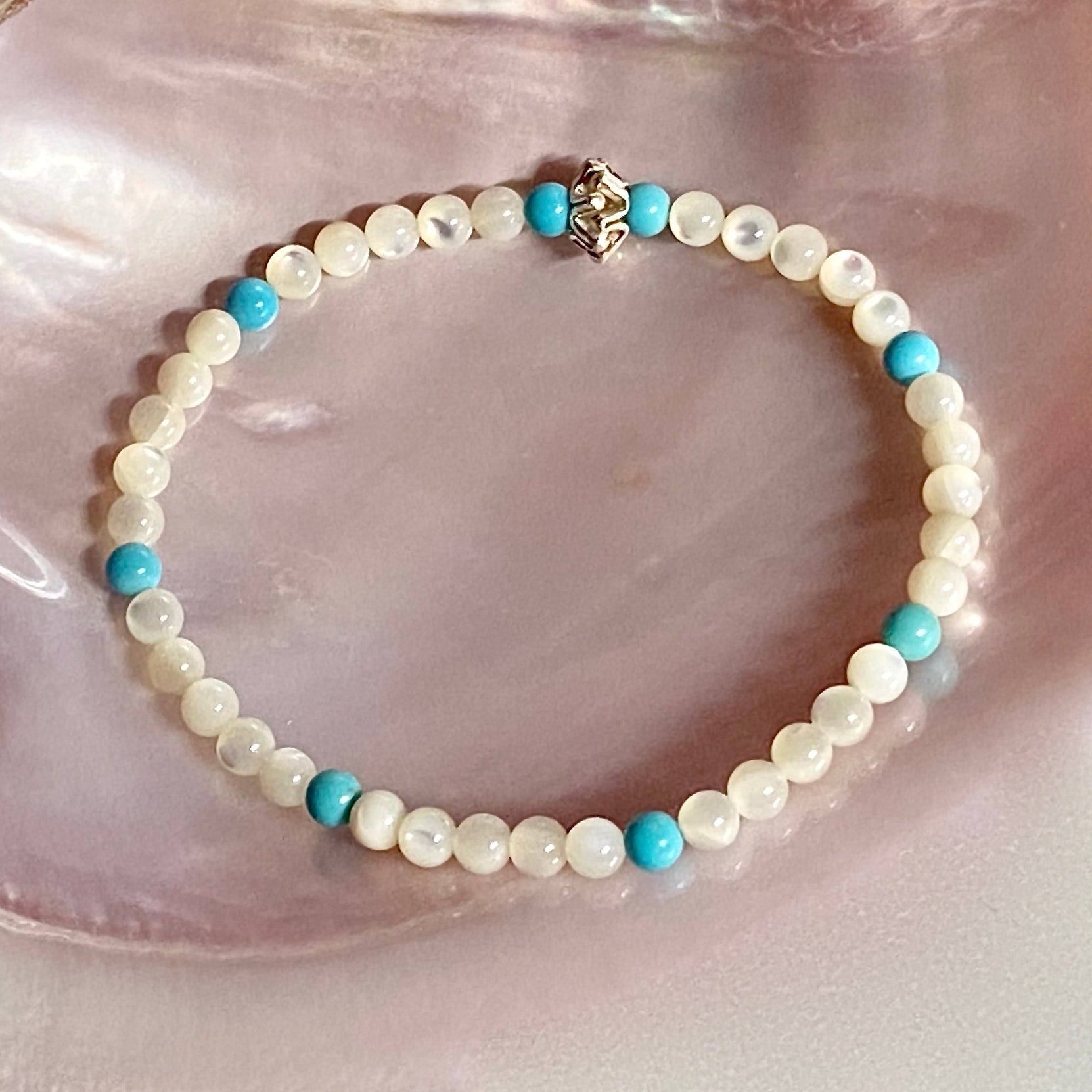 Between the Cominos white mother of pearl & sleeping beauty turquoise beachlove stretch bracelet by Kimberly Arpaia